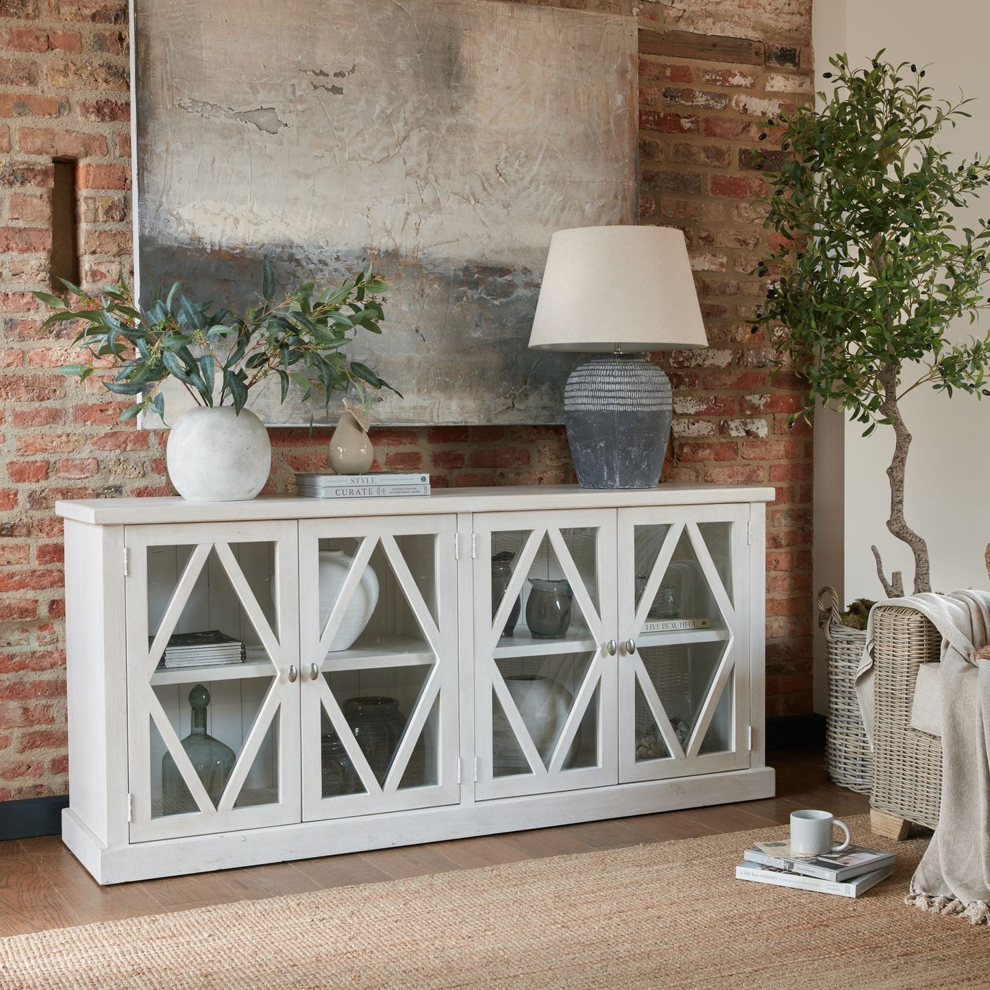 large artificial olive tree in right corner next to sideboard