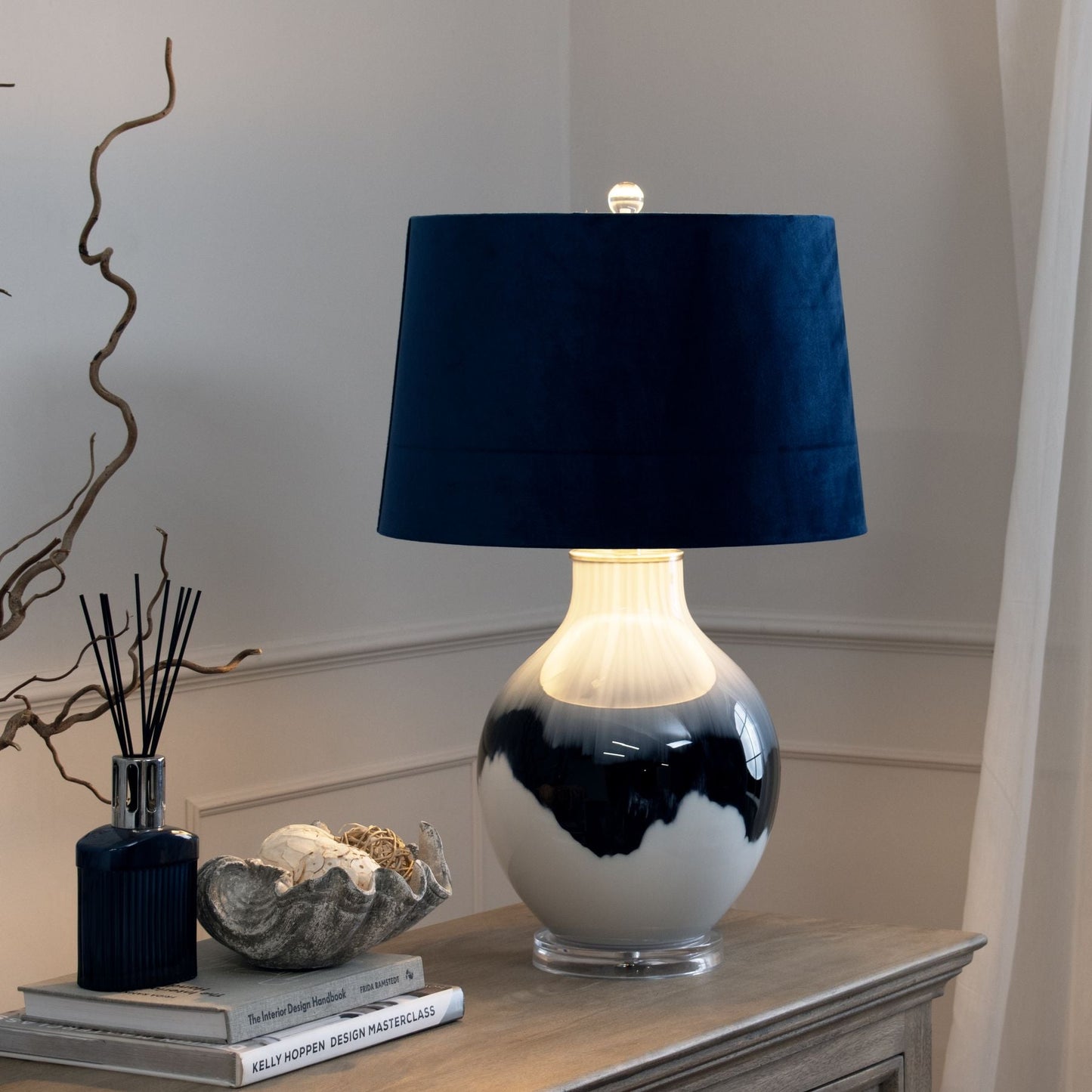 hand-dipped glass table lamp, lit up on sideboard
