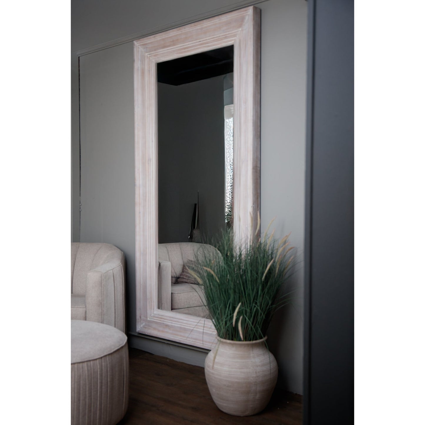 whitewashed large wooden mirror hanging on wall