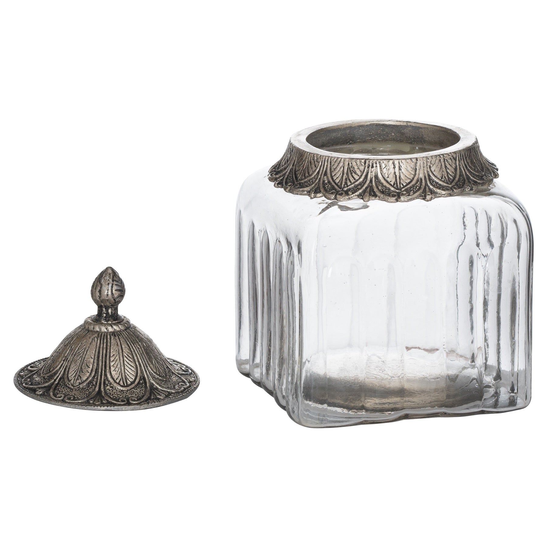 small handblown glass jar with the lid off and laid to the left side